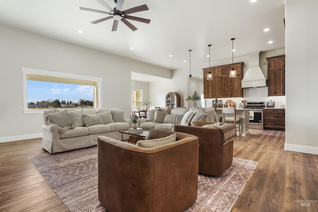 living room featuring ceiling fan and dark hardwood / wood-style floors