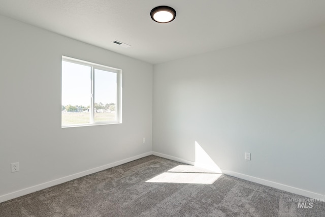 carpeted empty room with baseboards and visible vents