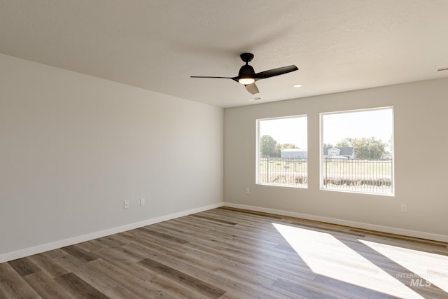 unfurnished room featuring recessed lighting, baseboards, wood finished floors, and a ceiling fan