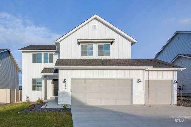 modern farmhouse featuring board and batten siding, concrete driveway, a shingled roof, and a garage