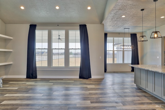 interior space with recessed lighting, a textured ceiling, and dark wood-style floors