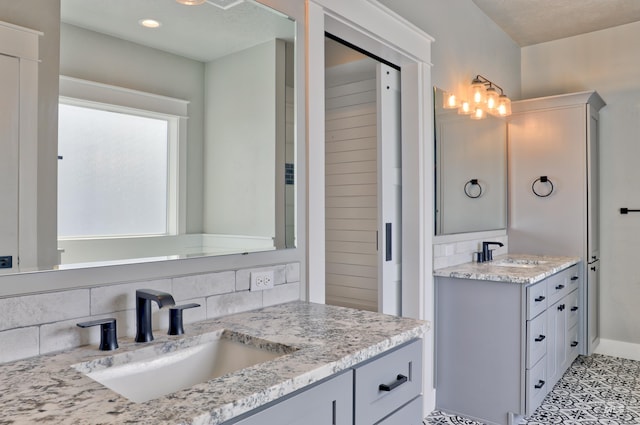 full bath with tasteful backsplash, two vanities, and a sink