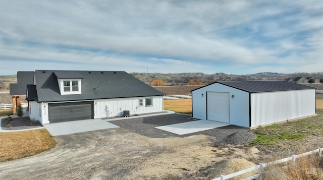 exterior space with cooling unit, an outdoor structure, and fence