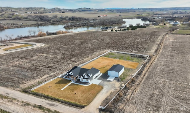 birds eye view of property with a rural view and a water view