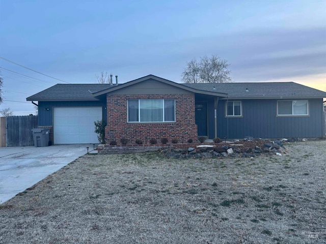 single story home featuring a garage and a front lawn