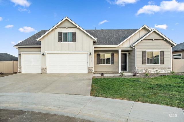 view of front of property with stone siding, board and batten siding, a front lawn, and fence