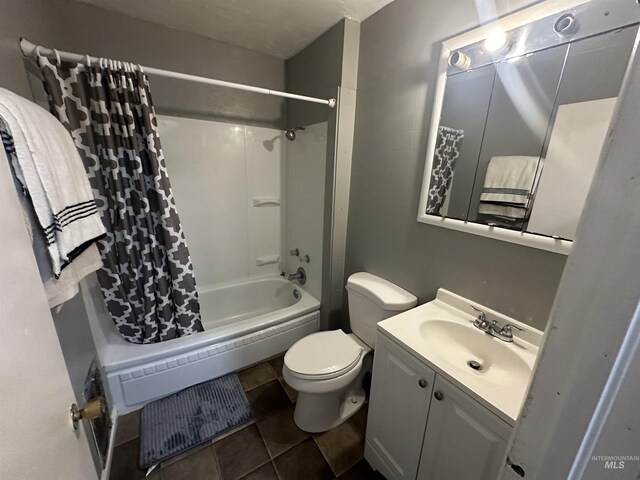 full bathroom with vanity, tile patterned floors, toilet, and shower / tub combo with curtain