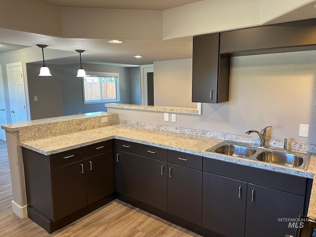 10331 W Utahna, Boise, ID 83714 - kitchen with a sink, light wood-type flooring, a peninsula, decorative light fixtures, and recessed lighting