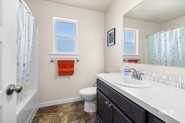 bathroom with baseboards, shower / bath combination with curtain, toilet, stone finish floor, and vanity