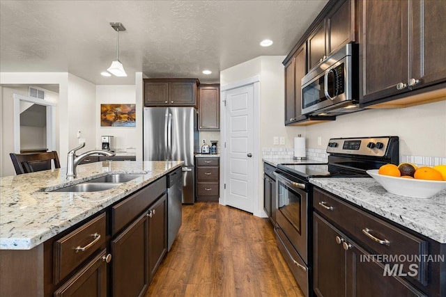 kitchen featuring a sink, dark wood-type flooring, dark brown cabinets, and stainless steel appliances