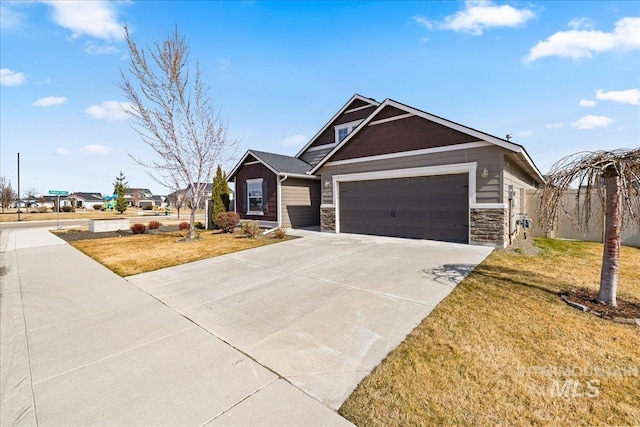 view of front of house featuring stone siding, a garage, concrete driveway, and a front lawn