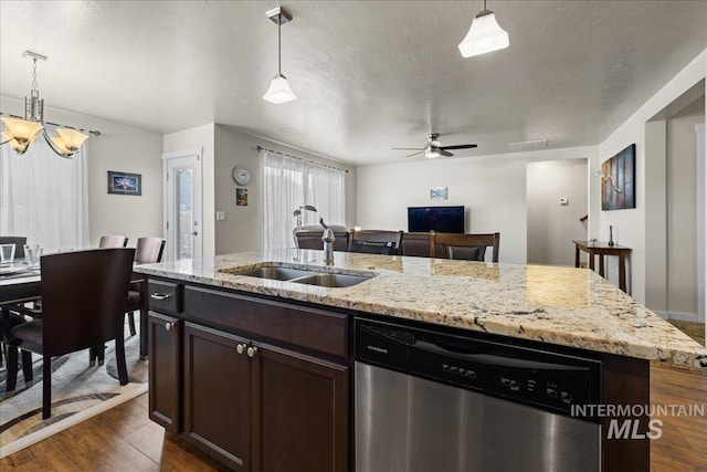 kitchen featuring dark wood finished floors, a sink, dark brown cabinets, pendant lighting, and stainless steel dishwasher