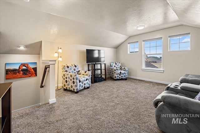 living area with vaulted ceiling, carpet, baseboards, and a textured ceiling