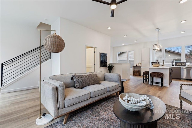 2031 S Makar Ln, Boise, ID 83706 - living room with light wood-style floors, ceiling fan, recessed lighting, stairway, and baseboards