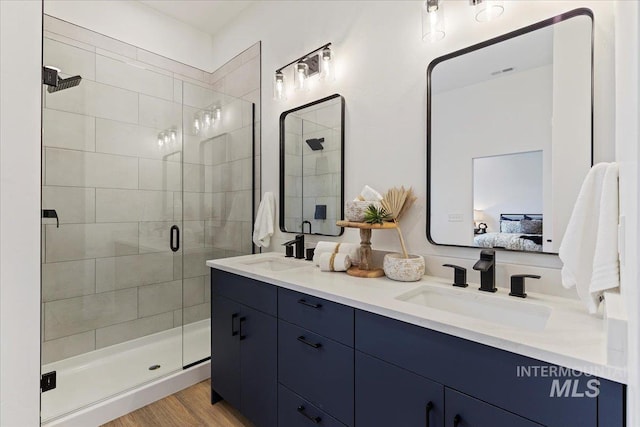 2031 S Makar Ln, Boise, ID 83706 - ensuite bathroom with double vanity, a shower stall, and wood finished floors