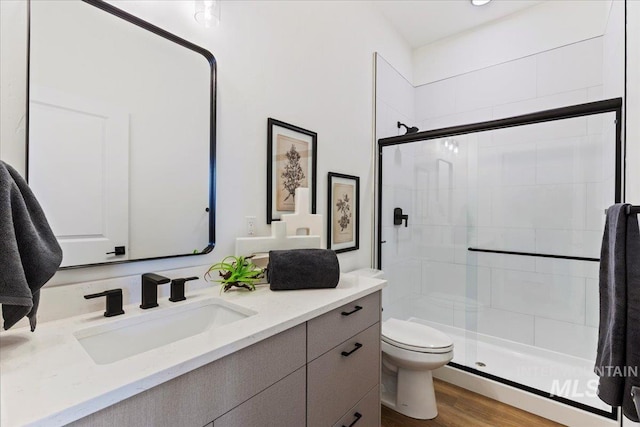 2031 S Makar Ln, Boise, ID 83706 - full bathroom with vanity, toilet, a shower stall, and wood finished floors