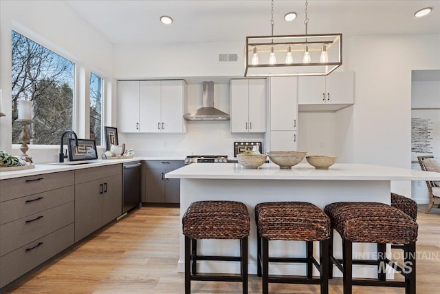 2031 S Makar Ln, Boise, ID 83706 - kitchen with wall chimney exhaust hood, a sink, stainless steel dishwasher, gray cabinets, and recessed lighting