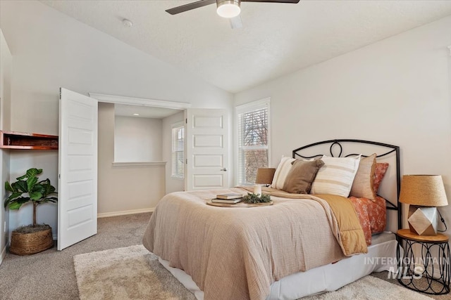 carpeted bedroom with baseboards, lofted ceiling, and a ceiling fan