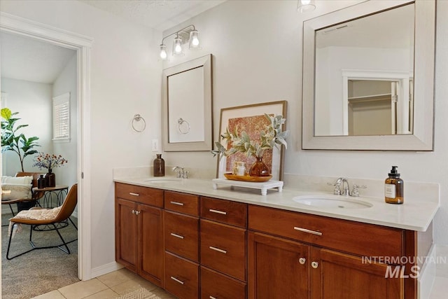 bathroom featuring double vanity, visible vents, tile patterned floors, and a sink