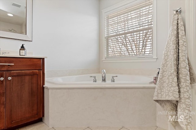 bathroom with a bath, visible vents, tile patterned flooring, and vanity