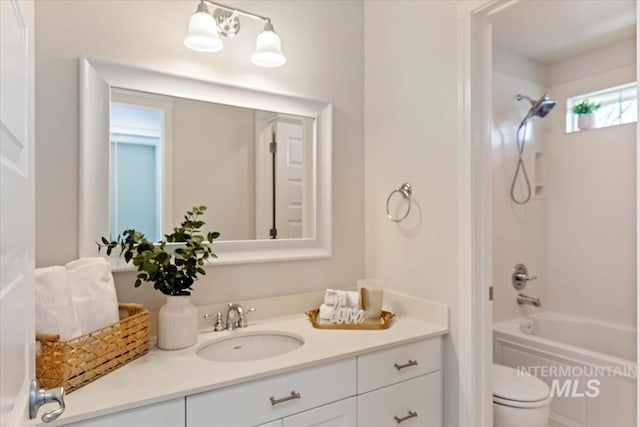 full bath with vanity, toilet, and washtub / shower combination