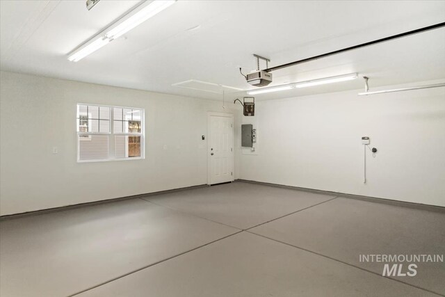 garage with electric panel and a garage door opener