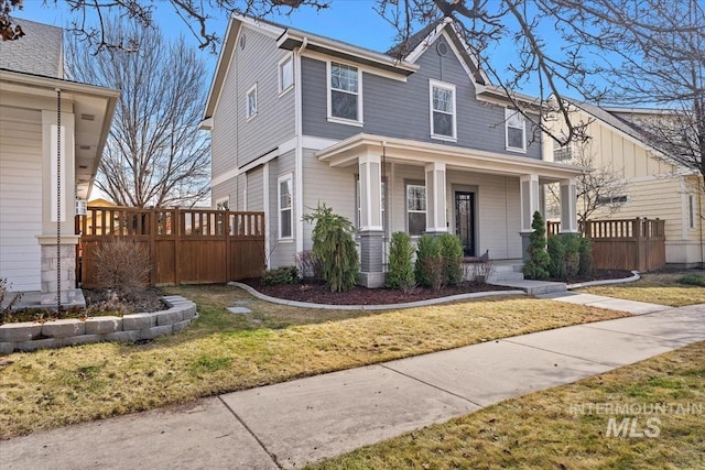 view of front of property with covered porch and a front lawn