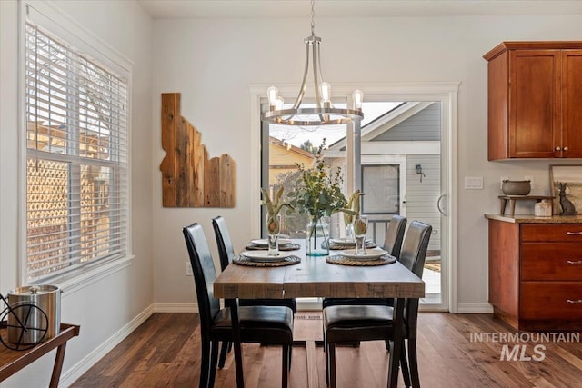 dining room with baseboards, dark wood-style flooring, and a chandelier