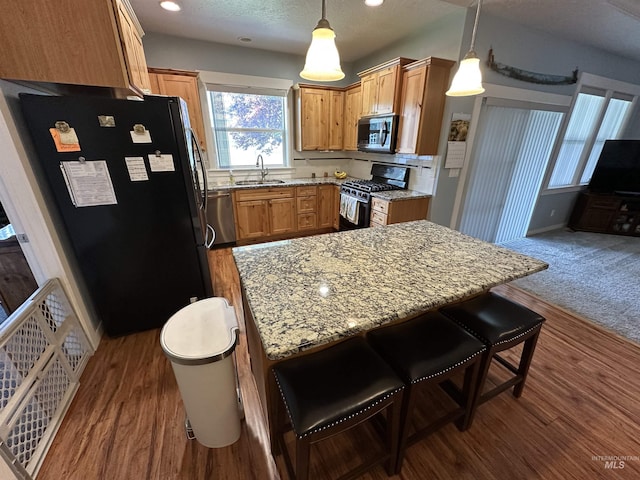 805 W Arbor Pointe Way, Nampa, ID 83686 - kitchen with appliances with stainless steel finishes, a sink, light stone countertops, hanging light fixtures, and recessed lighting