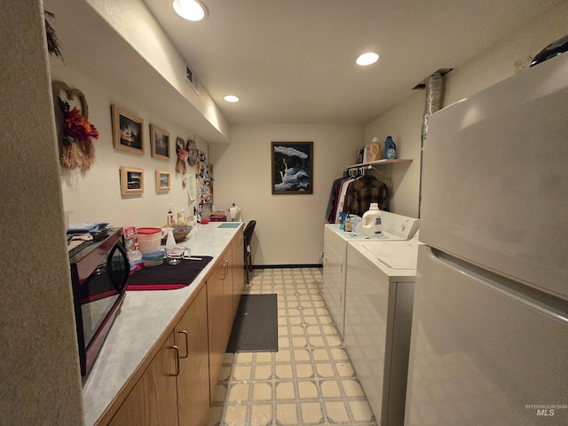 1230 Ellis Ave, Orofino, ID 83544 - kitchen with freestanding refrigerator, light flooring, washer and dryer, light countertops, and recessed lighting