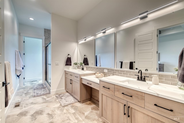 full bathroom with decorative backsplash, stone finish flooring, visible vents, a shower stall, and vanity