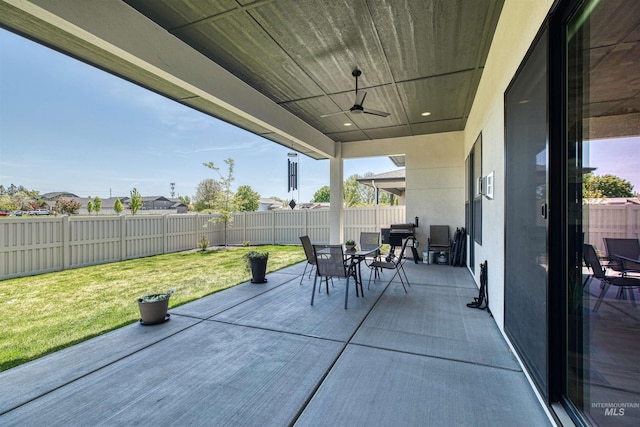 view of patio with a fenced backyard, outdoor dining space, and ceiling fan