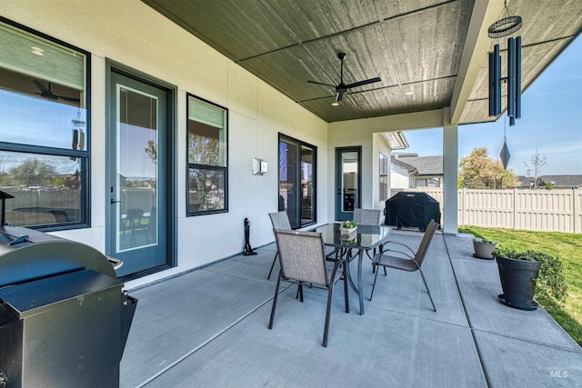 view of patio / terrace with ceiling fan, fence, area for grilling, and outdoor dining space