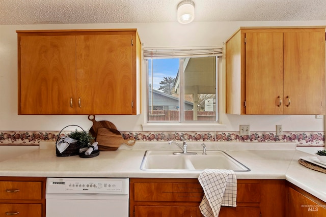 kitchen with light countertops, white dishwasher, a textured ceiling, and a sink