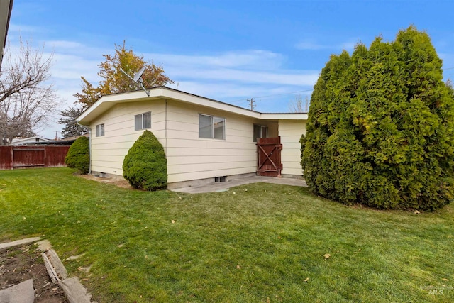 exterior space featuring a yard and fence