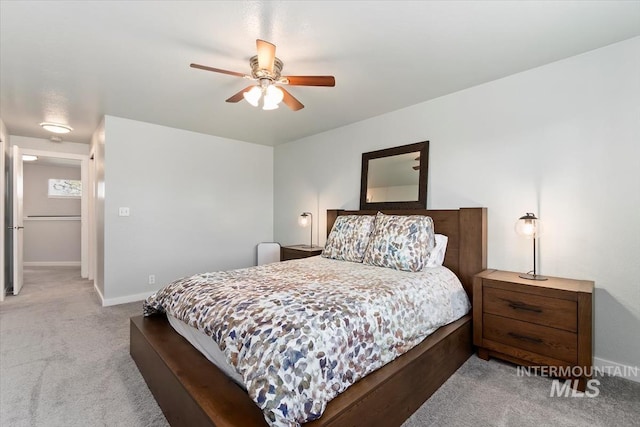 carpeted bedroom with baseboards and a ceiling fan