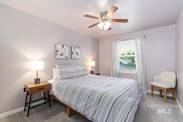 carpeted bedroom with baseboards and a ceiling fan