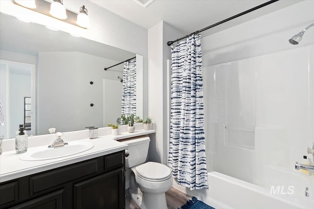 bathroom with vanity, shower / bath combination with curtain, and toilet