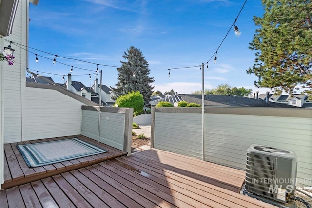 wooden deck featuring fence and central AC