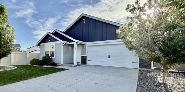 7575 S Cape View Way, Boise, ID 83709 - view of front of home with board and batten siding, driveway, an attached garage, and stone siding