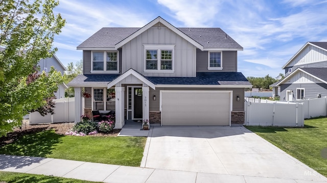 5015 S Marsala Way, Meridian, ID 83642 - view of front of property with board and batten siding, concrete driveway, an attached garage, a shingled roof, and stone siding
