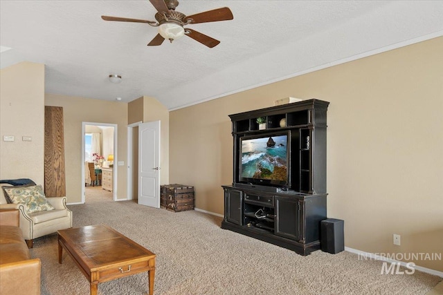 carpeted living room featuring ceiling fan and a textured ceiling