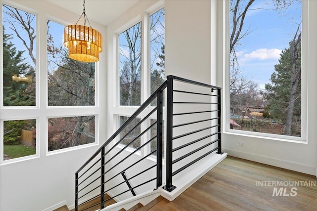 2007 S Makar Ln, Boise, ID 83706 - stairs with a chandelier, wood finished floors, and baseboards