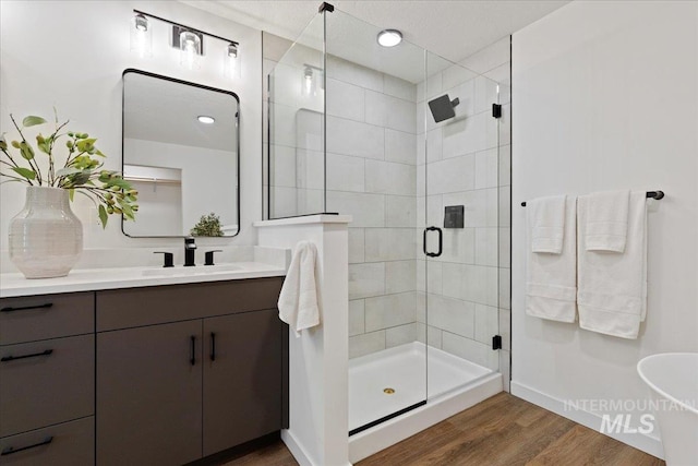 2007 S Makar Ln, Boise, ID 83706 - full bath with a stall shower, wood finished floors, vanity, and baseboards