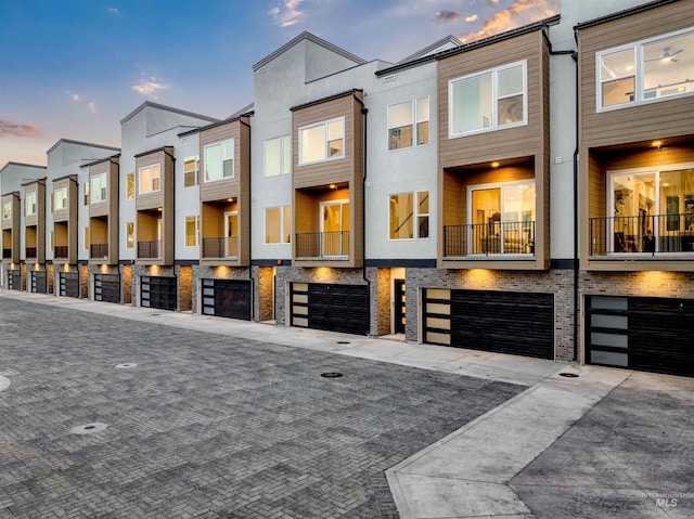 2007 S Makar Ln, Boise, ID 83706 - townhome / multi-family property with stucco siding, driveway, an attached garage, and a residential view