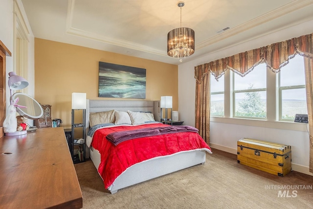 carpeted bedroom with visible vents, an inviting chandelier, baseboards, and a tray ceiling