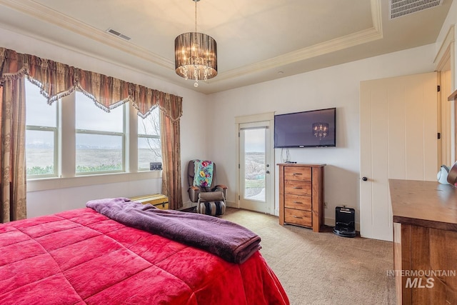 bedroom featuring a chandelier, visible vents, carpet, and a tray ceiling