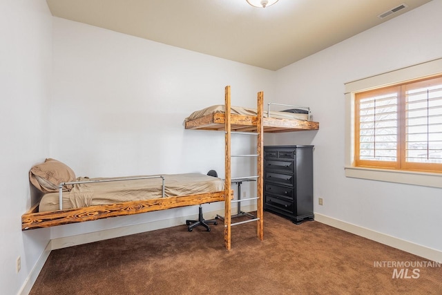 carpeted bedroom featuring visible vents and baseboards