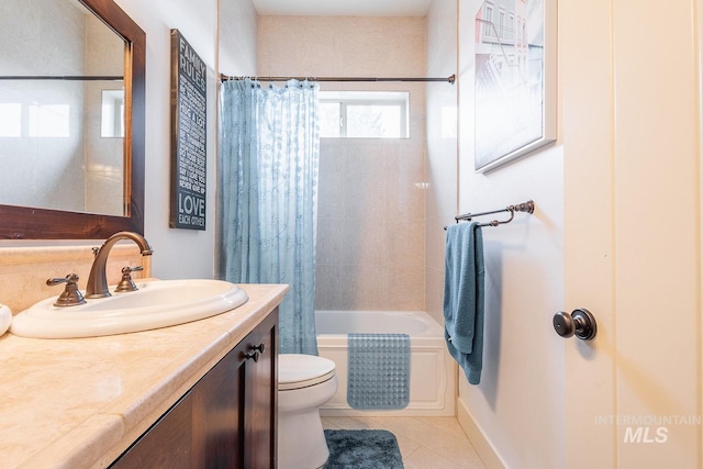 full bath featuring tile patterned floors, shower / bath combo with shower curtain, toilet, and vanity