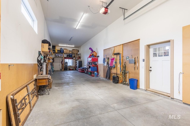 garage with a workshop area and a garage door opener